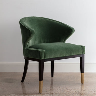 angled view of green velvet chair