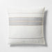 Decorative pillow with horizontal stripes on a light gray background