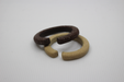 Two textured hairbands, one brown and one beige, on a light gray background.
