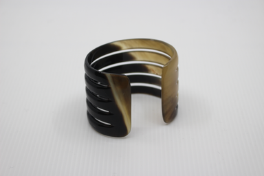 Black and gold bangle on a white background