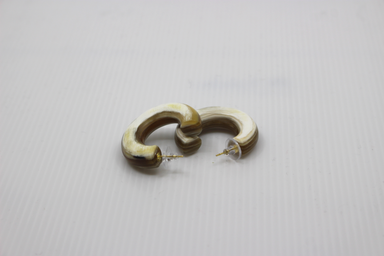 Pair of buffalo horn hoop earrings on a light gray background