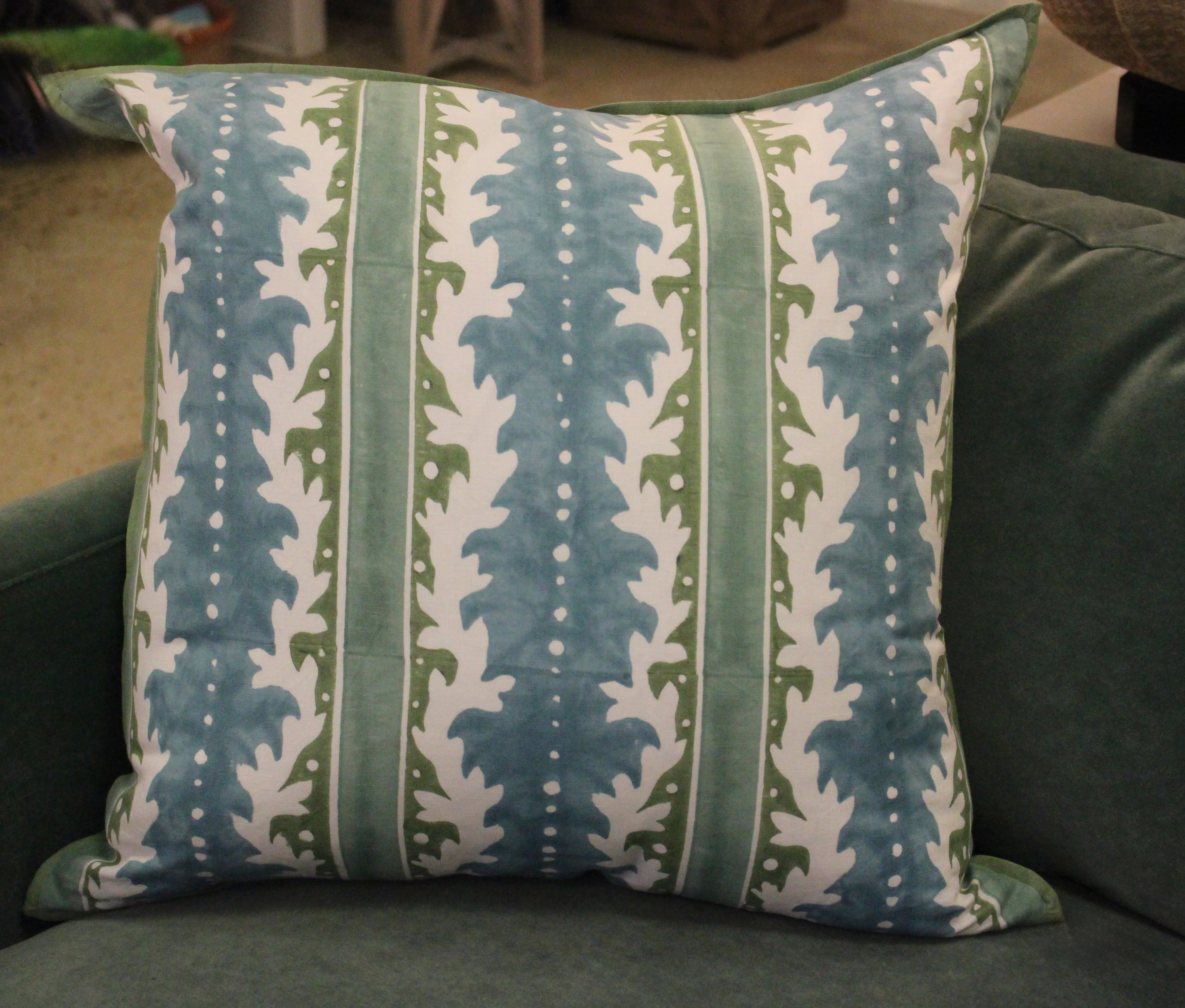 blue green striped pillow on green chair