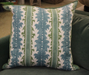 blue green striped pillow on green chair