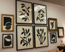 Wall with framed black and white abstract art pieces