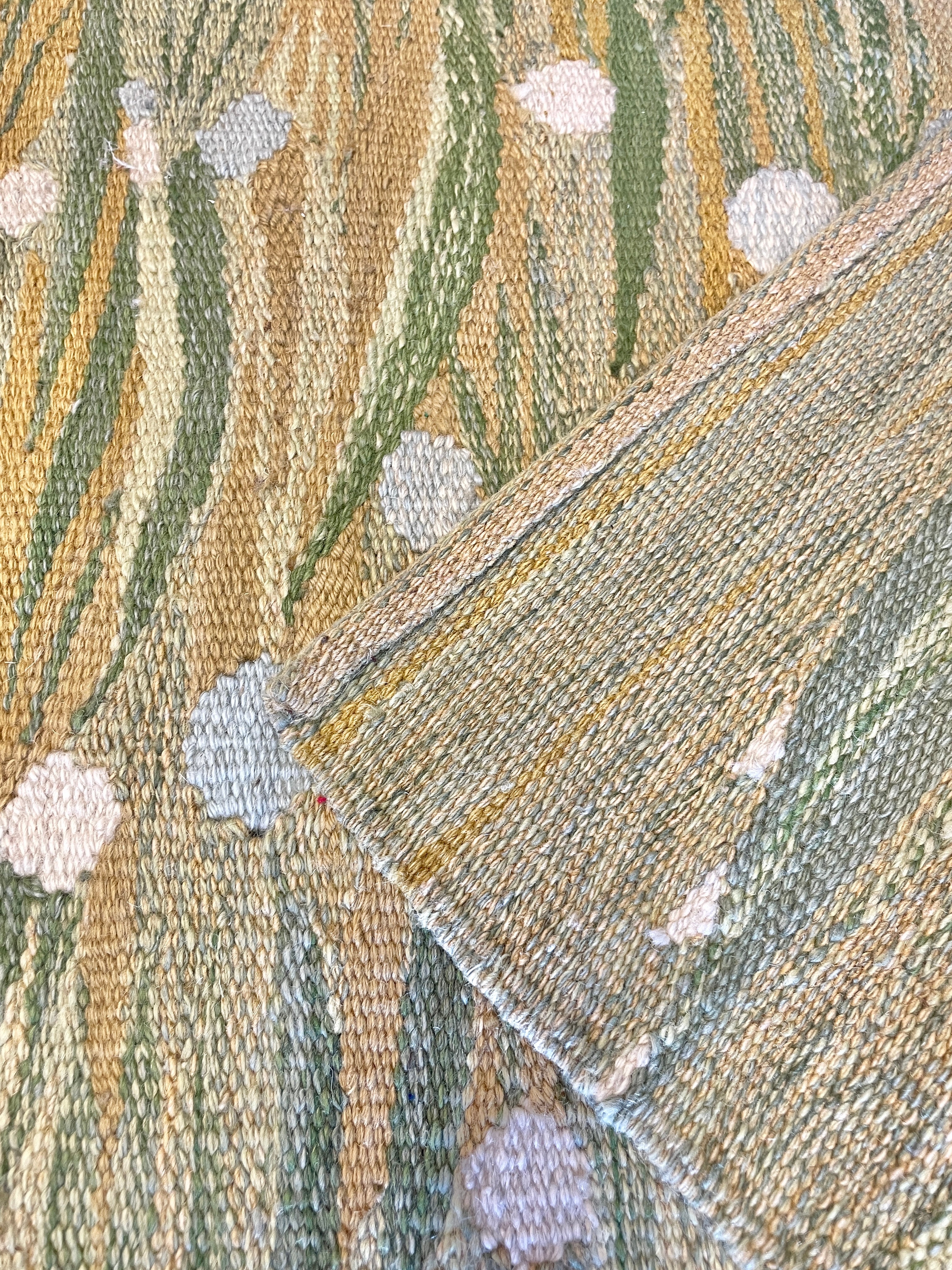 close up of both sides of flat weave wool rug