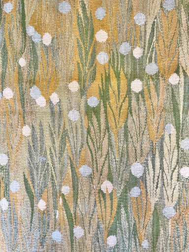 close up of green and yellow flat weave rug