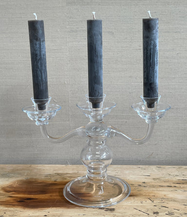 three arm glass candalabra with dark candles