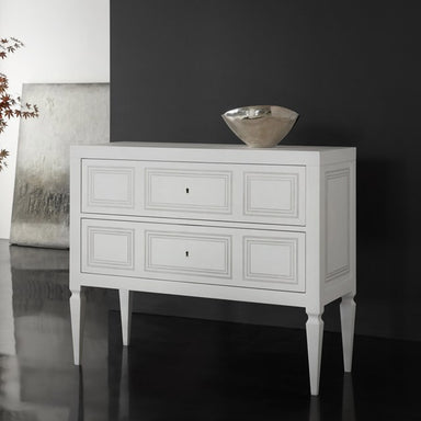 White chest with three drawers against a dark wall