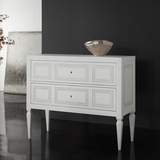 White chest with three drawers against a dark wall