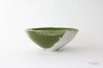 Green ceramic bowl on a white background