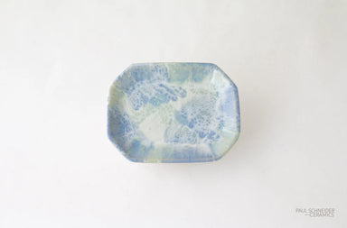 Rectangular ceramic dish with blue and green speckled pattern on a white background