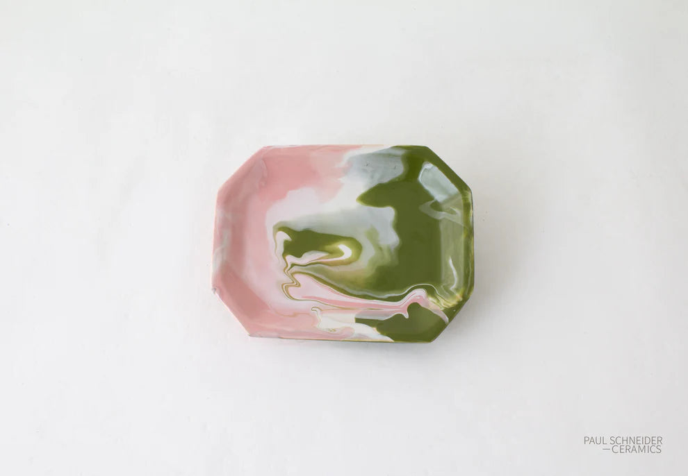 Hexagonal ceramic dish with pink and green marbled pattern on a white background