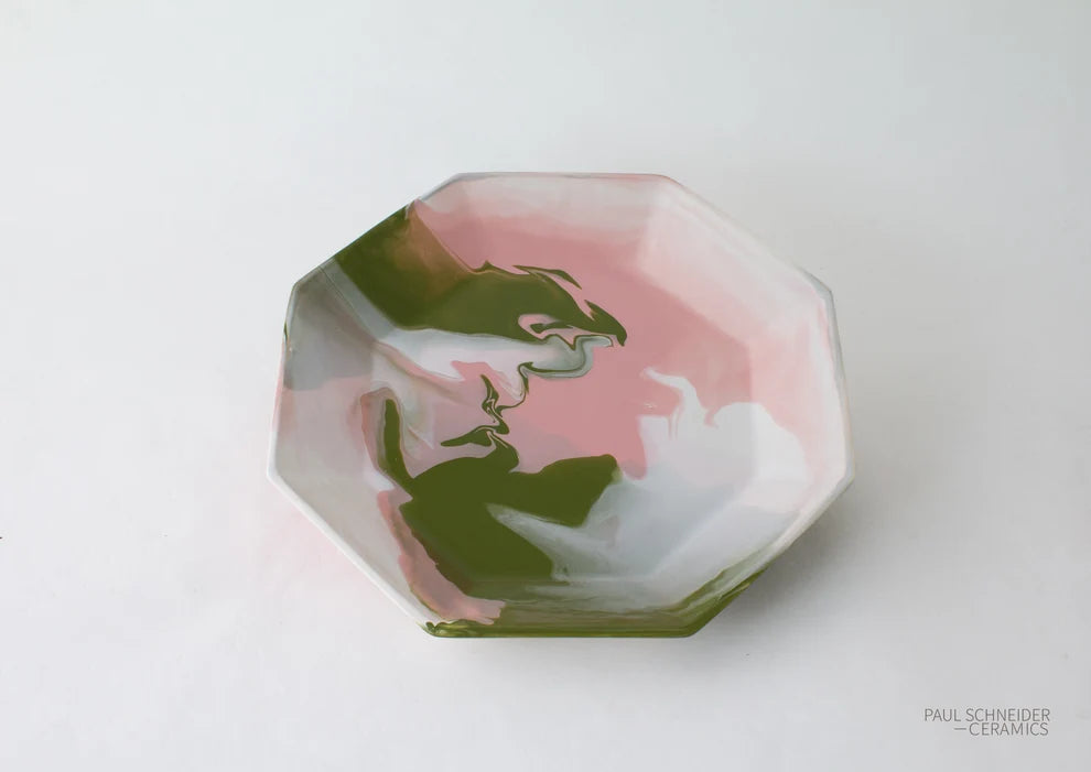 An octagonal ceramic tray with a marbled pattern of pink, white, and olive green, photographed from a top-down angle on a white background.