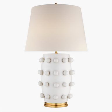 plaster white ceramic lamp with brass details and a linen shade