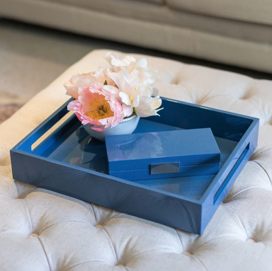 blue faux shagreen tray shown on ottoman with box and flowers