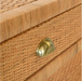 detail of brass pull on rattan side table
