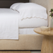 white scallop edge pillowcase on bed