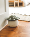 felted mushroom doorstop on floor by white door