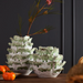 two white and green vases on tabletop