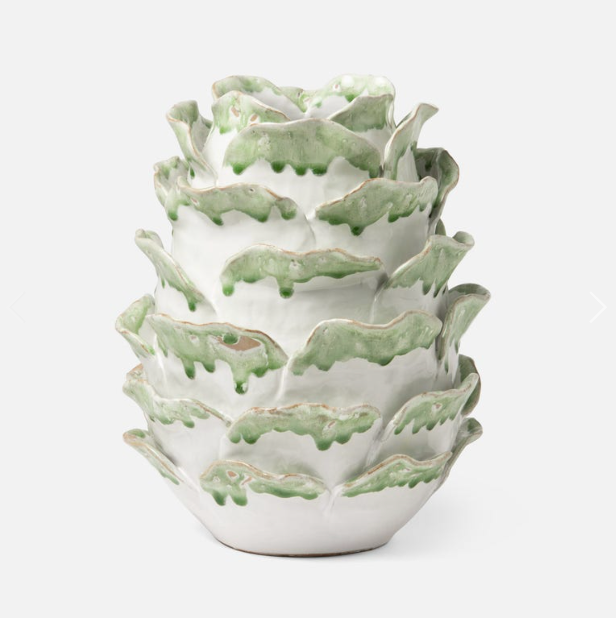 white ceramic vase with leaves edged in green