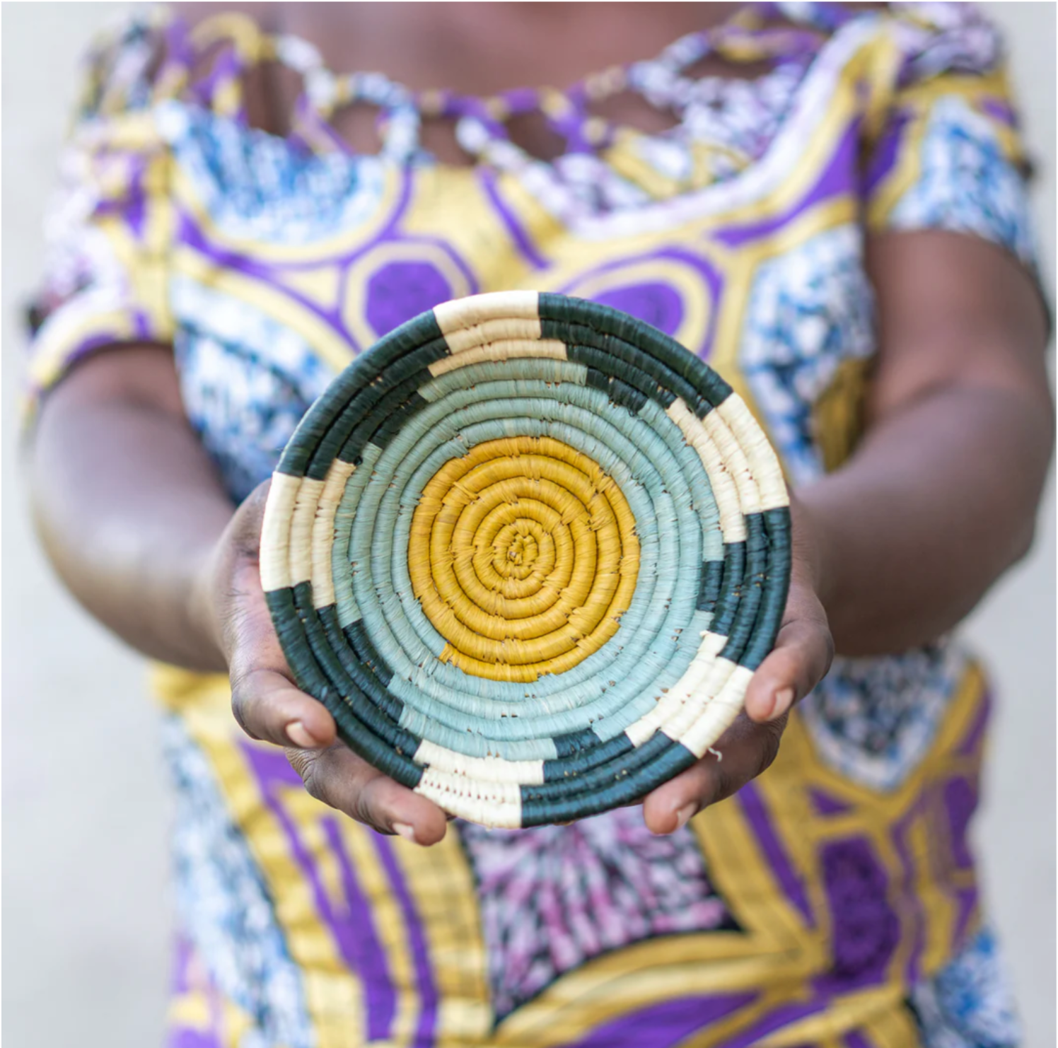 African woman showing off her colorful woven basket