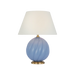 Table lamp with a blue glass base and white lampshade on a black background