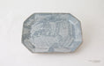 An octagonal ceramic plate with a textured, mottled blue and white glaze, photographed from a top-down angle on a white background.