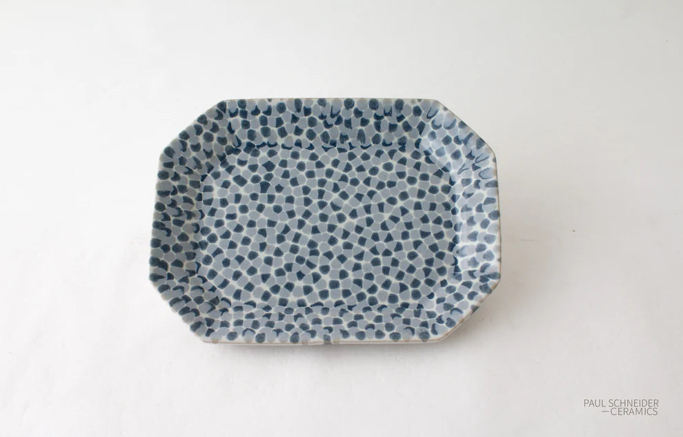 Rectangular ceramic plate with blue dot pattern on a white background, branded 'Paul Scheffer Ceramics'.