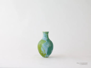 Green and blue ceramic vase on a white background