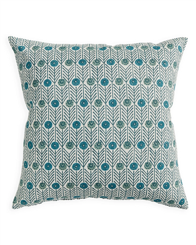 A square throw pillow featuring a repeating teal and green floral block-print pattern on a white fabric background, shown against a plain white studio backdrop.