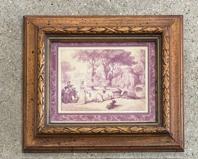 A framed art print featuring a vintage-style landscape illustration in muted purple and beige tones, set within an ornate distressed brown wooden frame against a textured gray concrete wall.