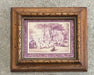 A framed art print featuring a vintage-style landscape illustration in muted purple and beige tones, set within an ornate distressed brown wooden frame against a textured gray concrete wall.