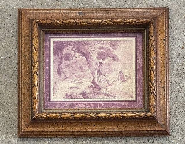 A framed art print featuring a vintage-style illustration of a figure in a landscape in muted purple and beige tones, set within an ornate, distressed brown wooden frame.