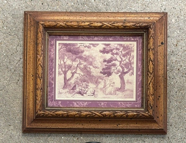 A framed art print featuring a sepia-toned landscape scene with trees and figures, surrounded by purple borders and an ornate brown wooden frame, mounted on a textured gray wall.