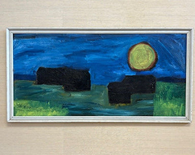 Framed painting of a night scene with a full moon and silhouettes on a beige wall.