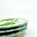 turquoise-color edge of stack of majolica plates