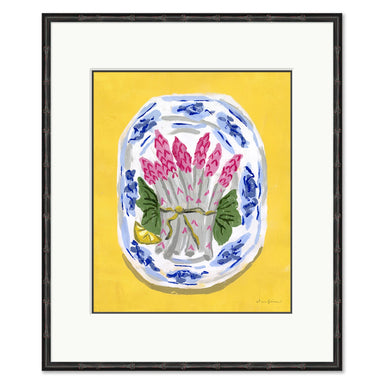 Framed artwork of a still life with pink asparagus and green leaves on a yellow background