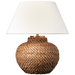 Table lamp with woven base and white shade on a white background