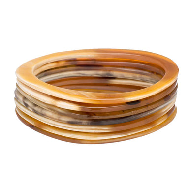 Set of tortoiseshell bangles on a white background