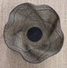 Black and beige woven hat on a beige surface