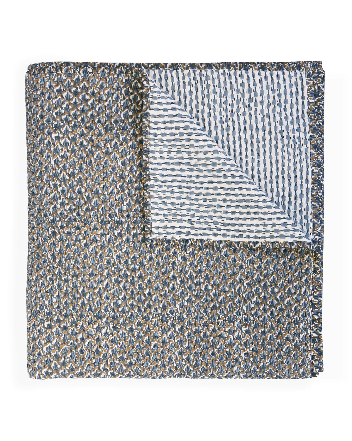 A folded quilt with a textured, speckled blue, gray, and beige pattern on one side and a contrasting block printed pattern in blue and beige on the reverse, shown on a plain white background.