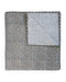 A folded quilt with a textured, speckled blue, gray, and beige pattern on one side and a contrasting block printed pattern in blue and beige on the reverse, shown on a plain white background.
