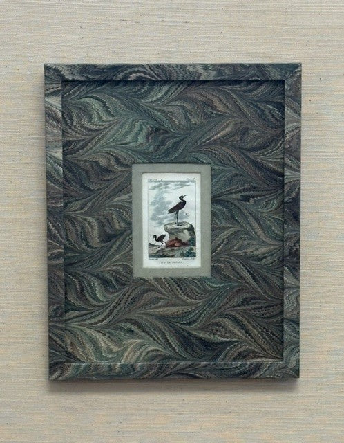 Decorative framed picture with a marbled design on a wooden surface