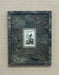 Decorative framed picture with a marbled design on a wooden surface