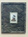 Framed artwork with a wavy pattern on a textured surface