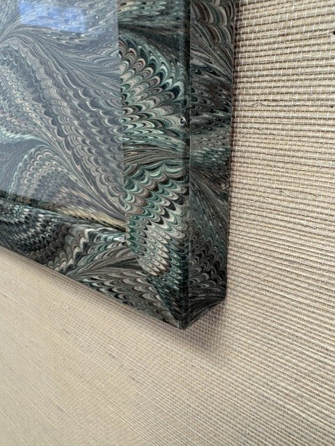 Close-up of a textured fabric with a marbled pattern on a beige background