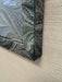 Close-up of a textured fabric with a marbled pattern on a beige background