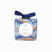 A square ornament picture frame by Artisans of Craft Rug, wrapped in a marbled blue, orange, and white patterned paper and tied with a navy blue ribbon, shown on a plain white background.