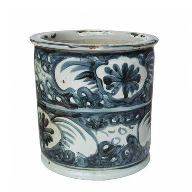 Blue and white ceramic vase with floral patterns on a white background