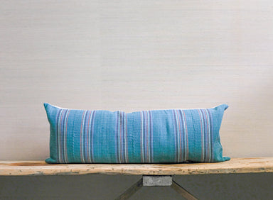 teal green base with orange, red and purple skinny stripes on handloomed textile bolster pillow